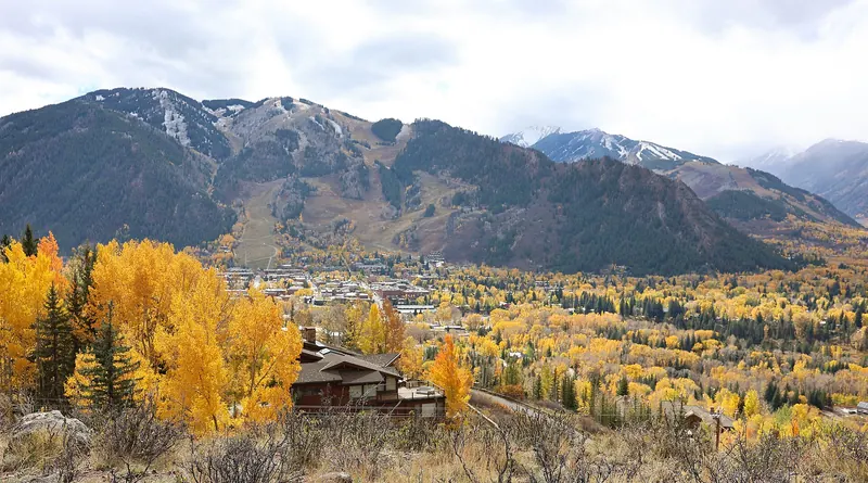 A view of Aspen, Colorado from a point along the Hunter Creek Trail. The view shows Bell Mountain and Aspen Mountain (the twin peaks on the left) and part of the town of Aspen.