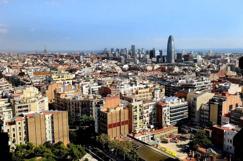 Barcelona, Spain, view over the city towards the coast with Torre Agbar, which is illuminate at night in the colours of the “F. C. Barcelona”