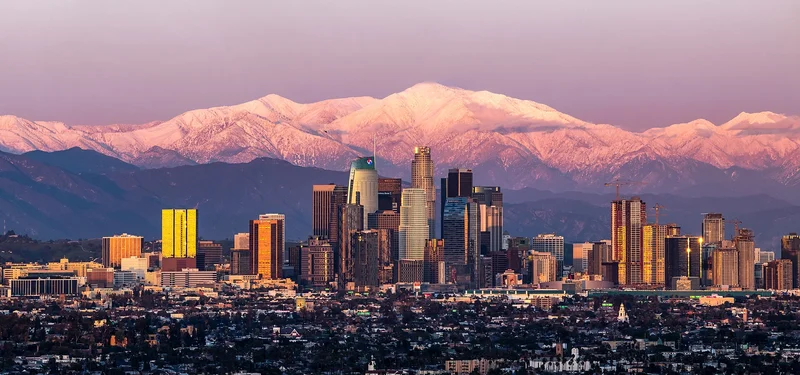 Downtown Los Angeles at sunset with snow-covered Mount Baldy after a February 2019 storm