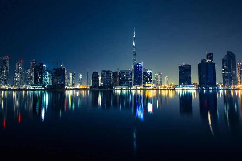 Dubai skyline reflected across the water at night, photographed in April 2016