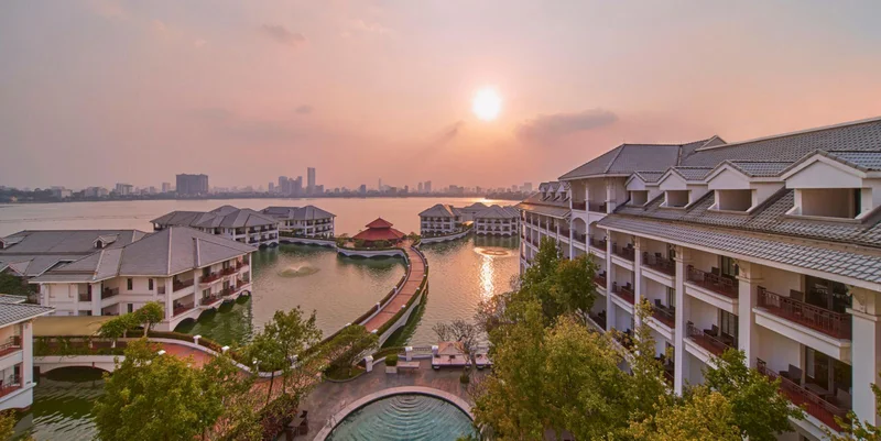 InterContinental Hanoi Westlake waterfront buildings at sunset
