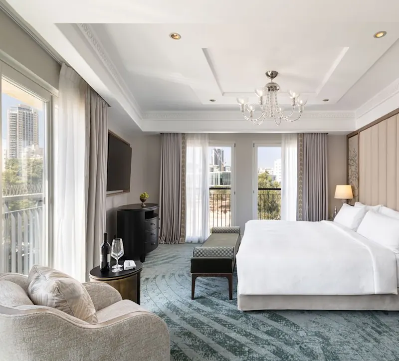 Large Bed in a Suite with Seating Area and Balcony