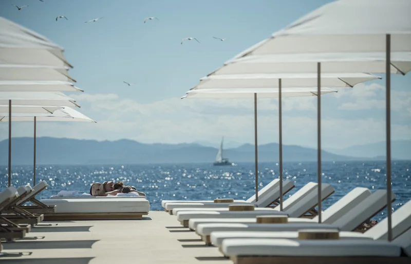 Sea-view terrace and loungers at Four Seasons Astir Palace Hotel Athens