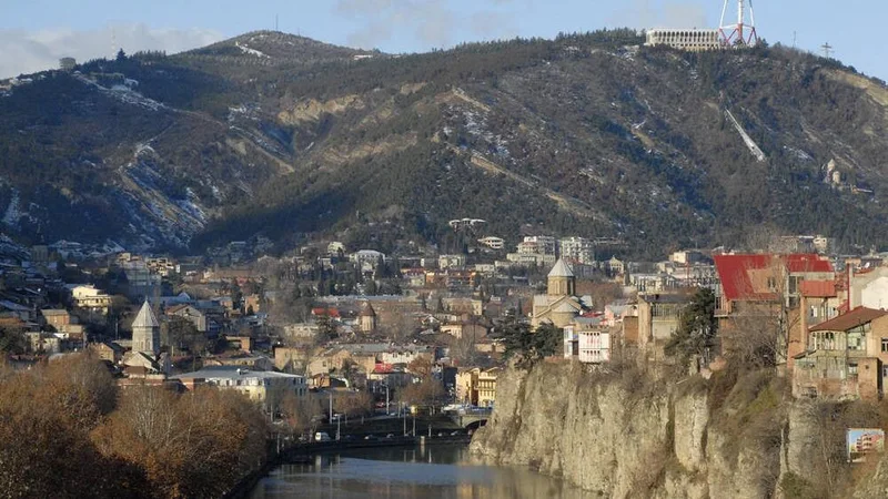 Tbilisi river, city buildings and hillside panorama
